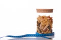 Mix of raw pasta in jar and measuring tape isolated on white background. Diet