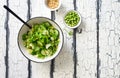 Mix salad leaves, cucumbers. pine nuts and green peas salad in white bowl Royalty Free Stock Photo