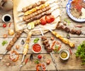 Mix of shish kebabs on skewers. on a wooden table Royalty Free Stock Photo