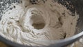 Mix the solution in a bucket using a construction mixer. Worker mixing plaster in a bucket for alignment and putty walls Royalty Free Stock Photo