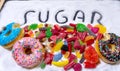 Candies donuts and sugar in writing Royalty Free Stock Photo