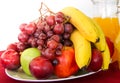 Mix of tropical organic fruits served on a plate and jugs of fresh juices