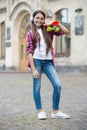 Mix vacation with urban roll. Happy child hold penny board outdoors. Skateboarding. Skate trip. Freedom and leisure Royalty Free Stock Photo