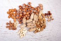 Mix of variety of nuts on white wooden background