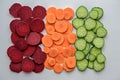 Mix of vegetable slices beetroot, carrot, cucumber on white background, vegetable composition