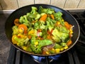 Mix of vegetables is fried in pan on stove Royalty Free Stock Photo