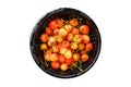 Mix of yellow and red ripe cherries in a colander. Isolated, white background. Royalty Free Stock Photo