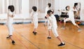 Mixed age group of athletes at fencing coach