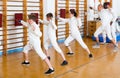 Mixed age group of athletes at fencing workout