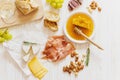 Mixed antipasti served on white wooden background.