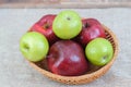 Mixed apples in basket on the table Royalty Free Stock Photo