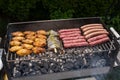 Mixed assortment of marinated meat, chicken, and prawns grilling on hot coals on a BBQ Royalty Free Stock Photo