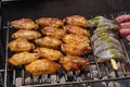 Mixed assortment of marinated meat, chicken, and prawns grilling on hot coals on a BBQ Royalty Free Stock Photo