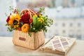 Mixed autumn flowers in basket with album with copy space