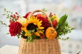 Mixed autumn flowers in basket, bouquet is on the windowsill. Royalty Free Stock Photo