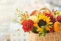 Mixed autumn flowers in basket, bouquet is on the windowsill with copy space. Royalty Free Stock Photo