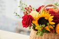 Mixed autumn flowers in basket, bouquet is on the windowsill with copy space. Royalty Free Stock Photo