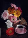 Mixed berbeda flower stilllife with a cup of tea and a book Royalty Free Stock Photo