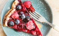 Mixed berries pie on blue ceramic plate Royalty Free Stock Photo