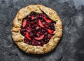 Mixed berries summer pie on a dark background, top view. Red, black currant, strawberry, raspberry sweet pie Royalty Free Stock Photo