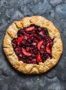 Mixed berries summer pie on a dark background, top view. Red, black currant, strawberry, raspberry sweet pie Royalty Free Stock Photo