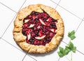 Mixed berries summer pie on a light background, top view. Red, black currant, strawberry, raspberry sweet pie Royalty Free Stock Photo