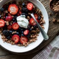 A mixed berry and granola breakfast bowl, topped with greek yogurt. Royalty Free Stock Photo