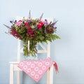 Mixed bouquet flowers on chair