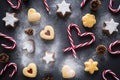 Christmas background with mixed Christmas cookies  candy canes  cones and powdered sugar  top view Royalty Free Stock Photo