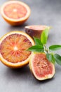 Mixed citrus fruit figs, limes on a gray background. Royalty Free Stock Photo