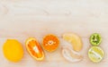 Mixed citruses fruit oranges, lemon and lime on wooden background with orange leaf. Royalty Free Stock Photo