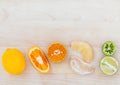 Mixed citruses fruit oranges, lemon and lime on wooden background with orange leaf. Royalty Free Stock Photo