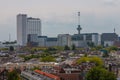 Mixed classic architecture of Rotterdam leafy urban apartment buildings in foreground with modern city high rise, tall towers and