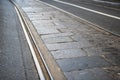 Mixed cobbles pavÃÂ¨ and tarmac city road with tramway tracks in Turin
