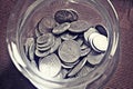 Mixed coins in glass cup Royalty Free Stock Photo