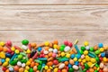 Mixed collection of colorful candy, on colored background. Flat lay, top view. frame of colorful chocolate coated candy Royalty Free Stock Photo