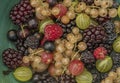 Mixed color garden fruit on wooden brown table and orange and green dish Royalty Free Stock Photo