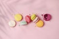 Mixed of colorful macaroni or pasta cake on a pink background with shadow. Sweet and colorful french macarons, pastel colors. Flat Royalty Free Stock Photo