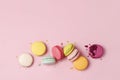 Mixed of colorful macaroni or pasta cake on a pink background. Sweet and colorful french macarons, pastel colors. Flat lay, top Royalty Free Stock Photo