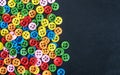 Mixed coloured bright buttons on a black background Royalty Free Stock Photo