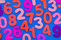 Mixed coloured numbers on a blue background. Royalty Free Stock Photo
