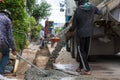 Mixed concrete pouring at construction site. Pouring cement during sidewalk upgrade. Royalty Free Stock Photo