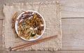 Mixed of crispy worm and insects in a ceramic plate with chopsticks on a wood table. The concept of protein food sources from Royalty Free Stock Photo