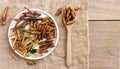 Mixed of crispy worm and insects in a ceramic plate with chopsticks on a wood table. The concept of protein food sources from Royalty Free Stock Photo