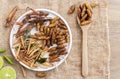 Mixed of crispy worm and insects in a ceramic plate with chopsticks on a wood table. The concept of protein food sources from Royalty Free Stock Photo