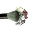 Mixed crushed make up eyeshadow with brush. Isolate on white