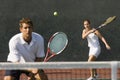 Mixed Doubles Player Hitting Tennis Ball