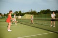 Mixed doubles tennis training, outdoor court