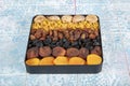 Mixed dried fruits box. Dried fruit background. Rows of dried dates, apricots, raisins, hazelnuts, dried apricots and figs Royalty Free Stock Photo