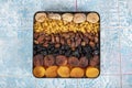 Mixed dried fruits box. Dried fruit background. Rows of dried dates, apricots, raisins, hazelnuts, dried apricots and figs Royalty Free Stock Photo